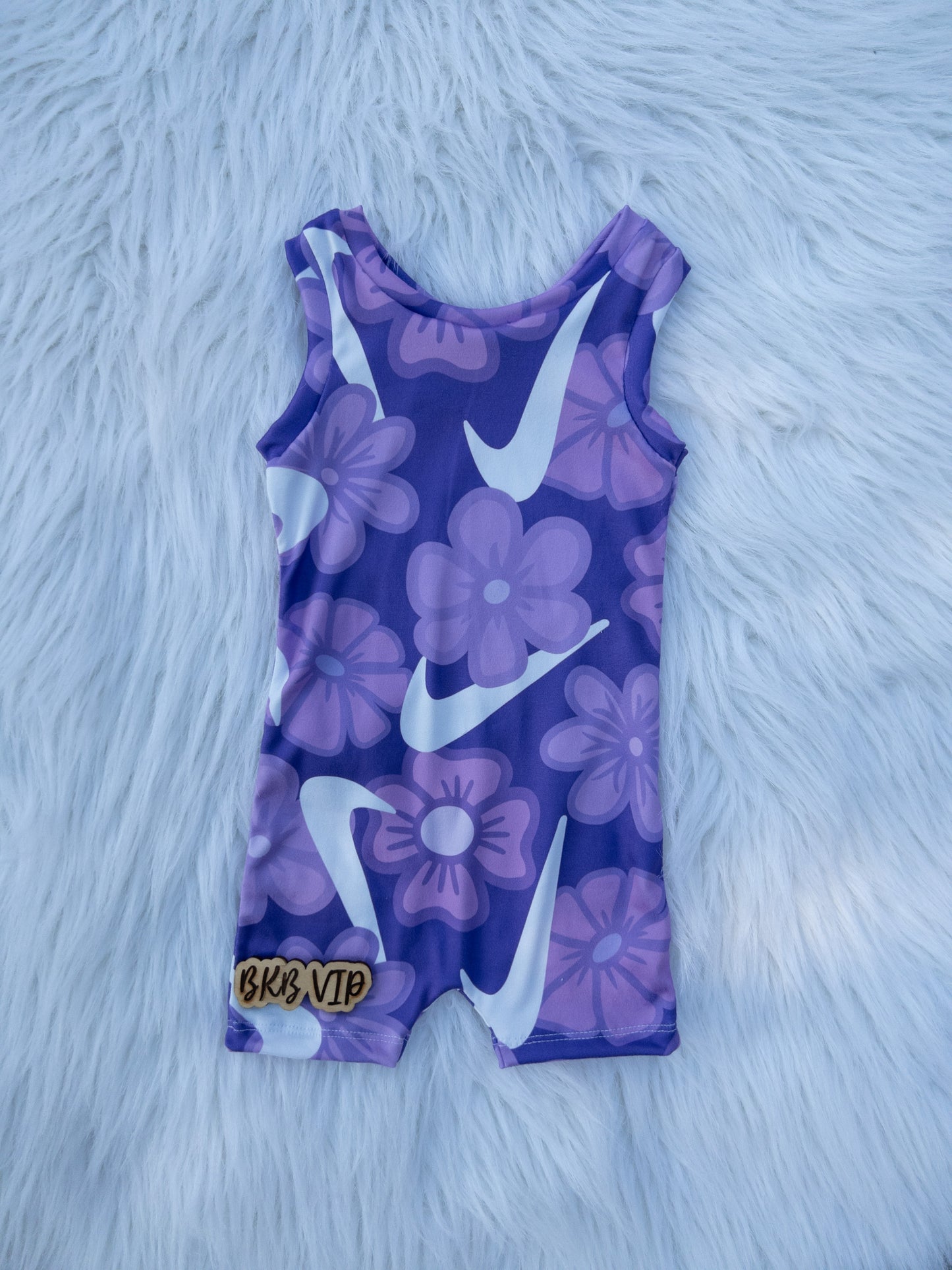 Purple floral swoosh Ollie romper