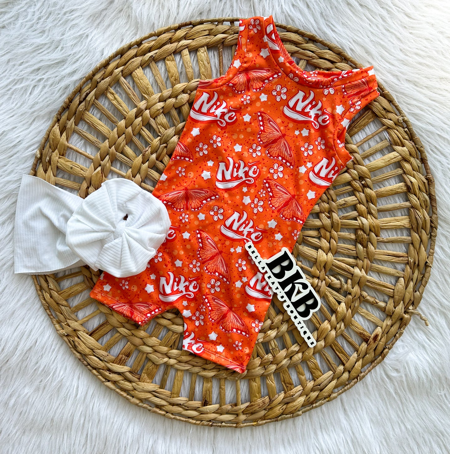 Orange butterfly swoosh Ollie romper